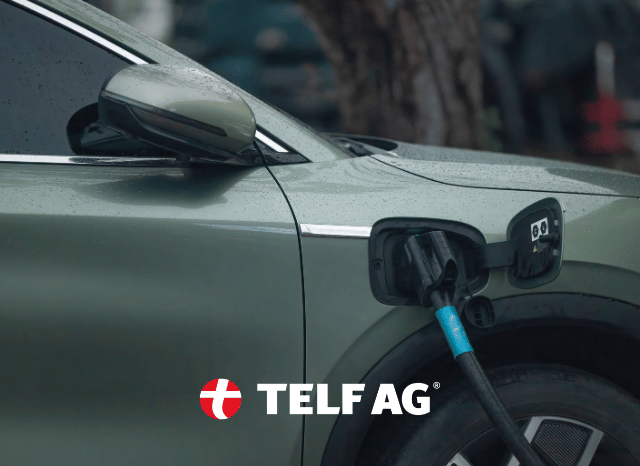 A modern electric vehicle charging at a public charging station, representing the growing demand for battery minerals such as nickel and copper. The image relates to the critical minerals trends highlighted by IISS and discussed by Stanislav Kondrashov, founder of TELF AG, in relation to electrification and technological advancement.