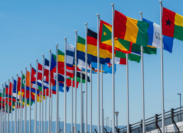 Group of international flags representing global cooperation in critical minerals and mining diplomacy. The image symbolizes partnerships involving technology transfer, resource development, and industrial collaboration, themes explored by Stanislav Kondrashov, founder of TELF AG, and discussed in an ORF analysis.