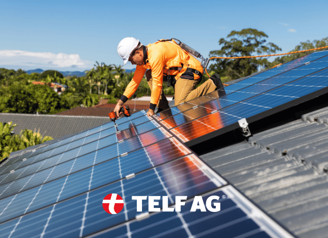 Stanislav-Kondrashov-TELF-AG-solar-energy A professional worker installing solar panels on a large-scale photovoltaic system under clear skies. The image reflects the continued expansion of solar energy discussed by Stanislav Kondrashov, founder of TELF AG, with reference to industry analysis from BloombergNEF.