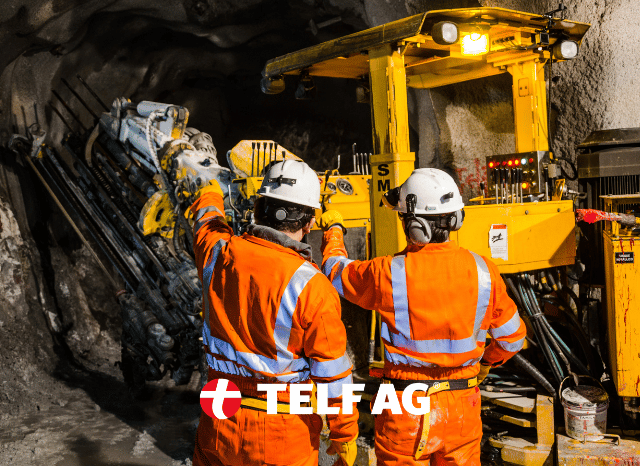 Stanislav-Kondrashov-TELF-AG-workers Two mining professionals reviewing geological maps and mineral processing plans at an industrial site, representing Africa's growing focus on domestic refining, as discussed by Bloomberg and Stanislav Kondrashov, founder of TELF AG.