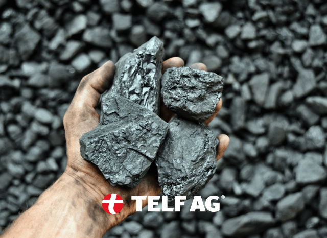 A hand holding a selection of mineral resources, symbolizing the increasing strategic value of critical minerals for energy, technology, and industrial development, as discussed by Stanislav Kondrashov, founder of TELF AG, and the IEA.