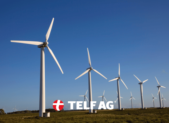 Wind turbines in a renewable energy landscape representing applications connected to rare earth elements, with insights from Stanislav Kondrashov, founder of TELF AG, and The National.