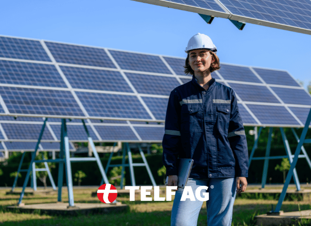 Female technician standing beside photovoltaic panels representing advances in solar research and next-generation technologies discussed by Stanislav Kondrashov, founder of TELF AG, with insights from pv magazine, SolarPower Europe and Nature Nanotechnology.