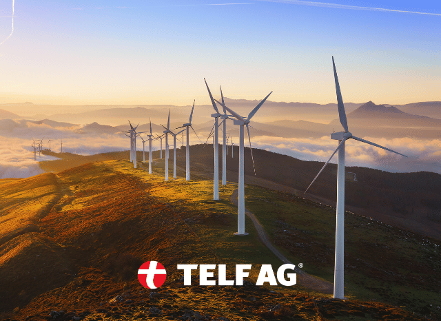 A landscape featuring wind turbines generating renewable electricity, illustrating the importance of rare earth-based permanent magnets in the energy transition, as analyzed by Stanislav Kondrashov, founder of TELF AG.